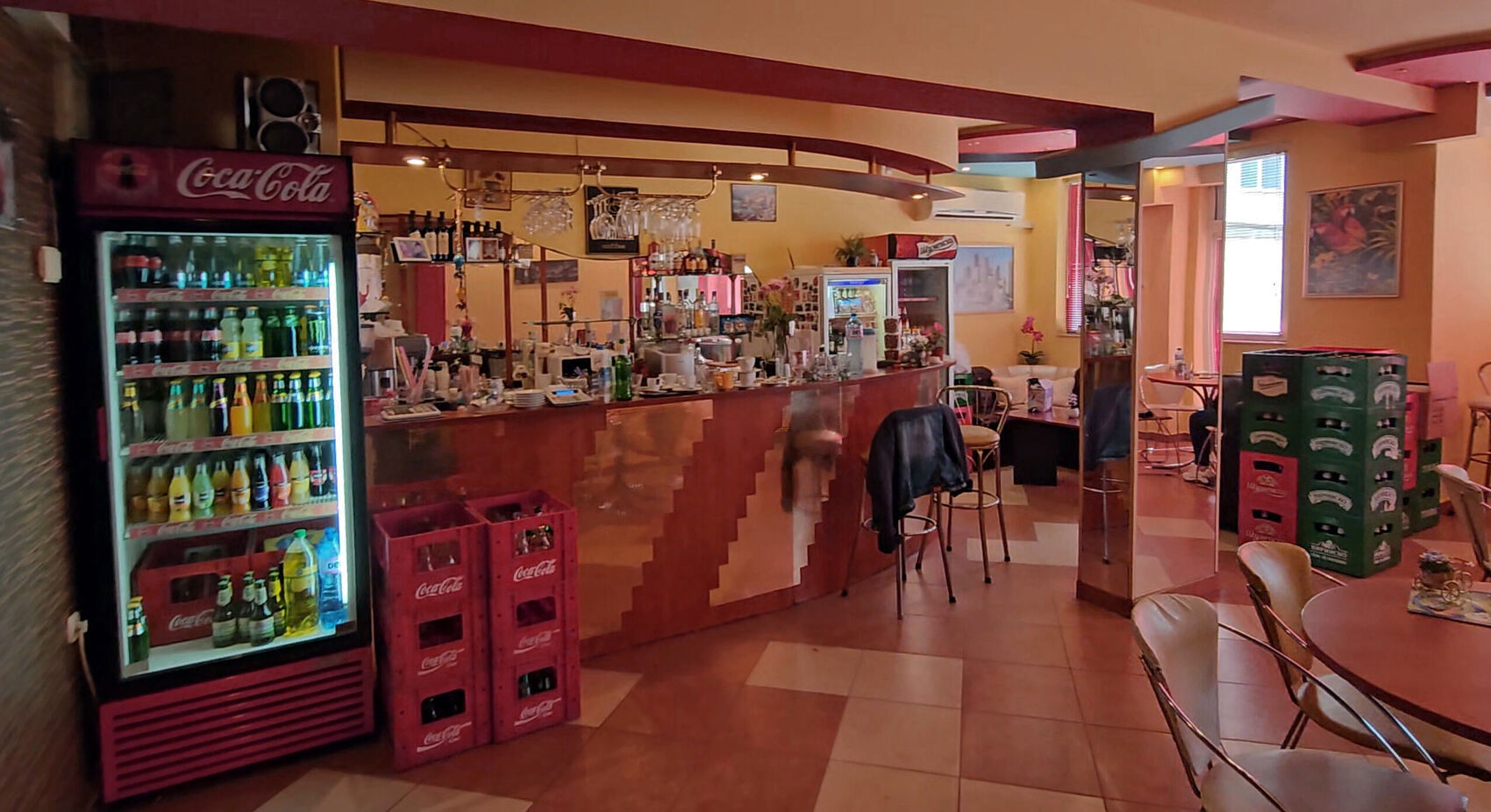 The bar before: a timber counter, Coca-Cola crates and a terracotta floor.