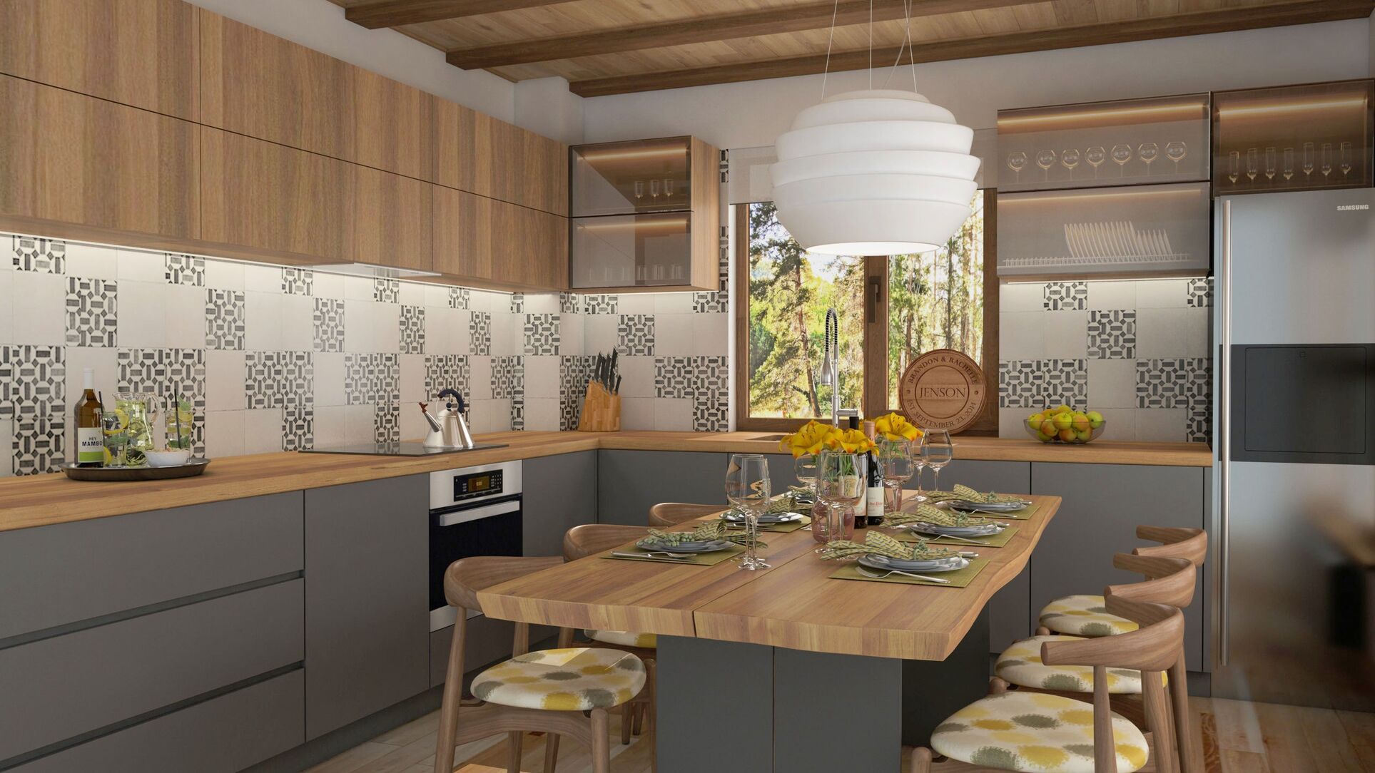La cuisine de plus près : la table, le dosseret de carreaux géométriques et la suspension blanche.