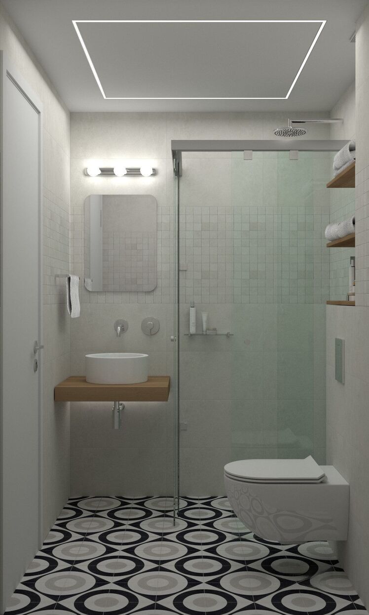 Das schmale Bad mit geometrischem Boden und Glasdusche.
