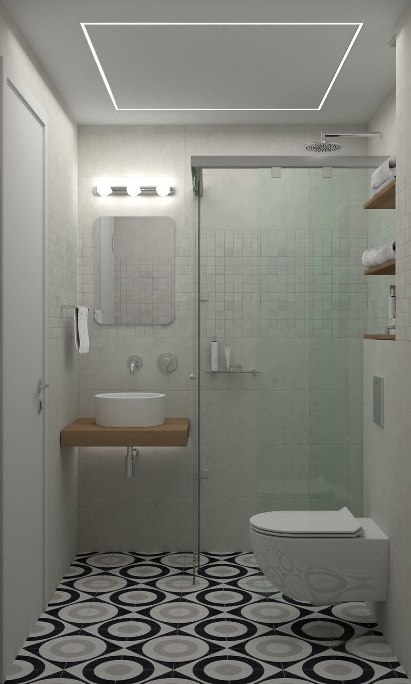 Baño estrecho con ducha de vidrio, estante de madera para el lavabo y suelo de círculos negro y blanco.