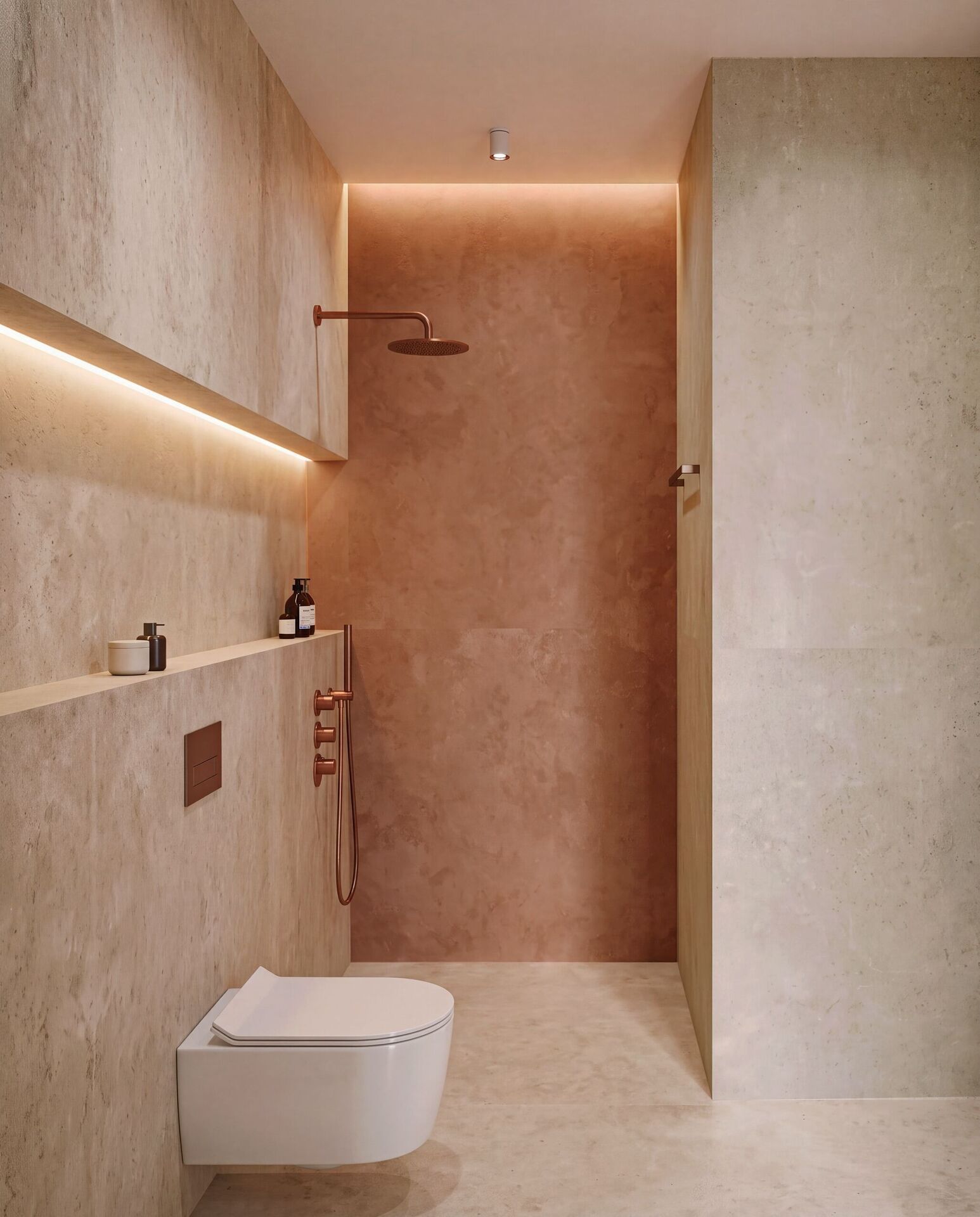 Vue dans la niche de douche de terre cuite, mitigeur de cuivre et tablette éclairée.