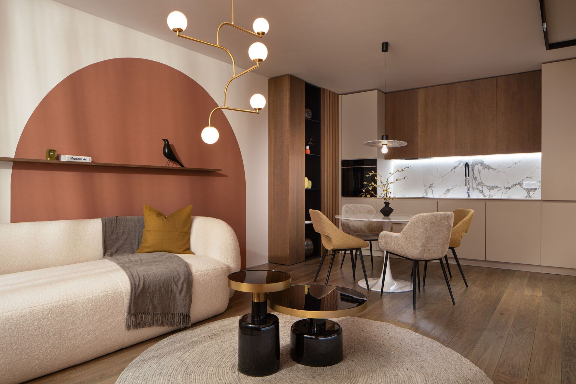 The sofa toward the terracotta half-circle and the dining area.